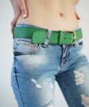 Jeans with scuffs and a green belt