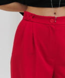 Women's light red palazzo pants with pleats.