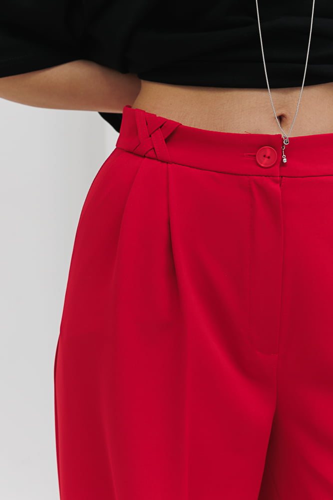 Women's light red palazzo pants with pleats.