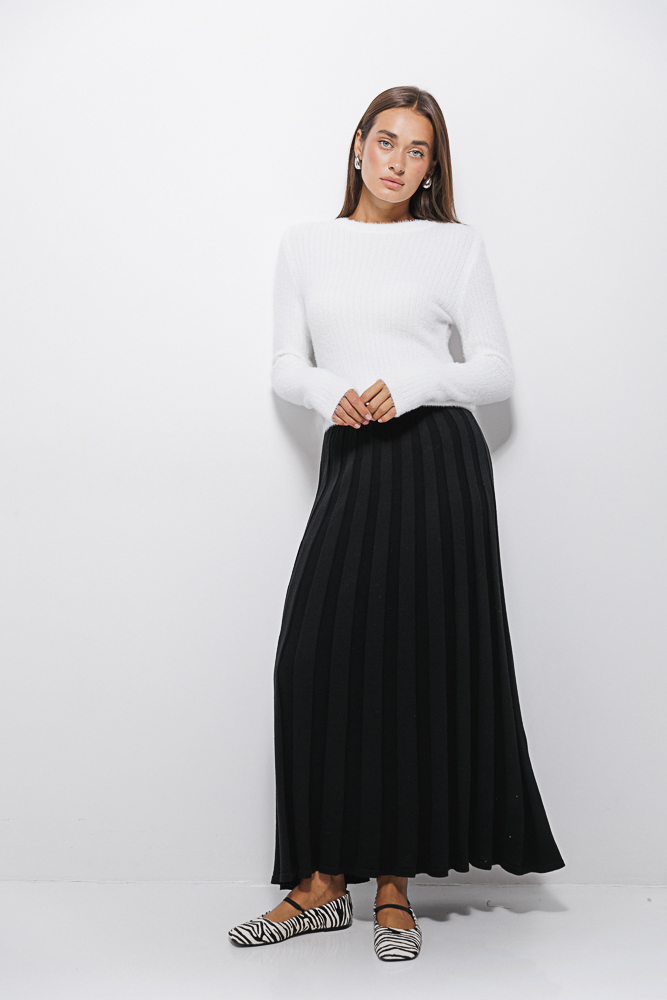 Long black knitted skirt with a pleated effect.