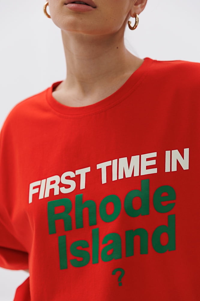 Women's light red oversized t-shirt with the print "First time in Rhode Island?"