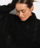 Knitted women's sweater black with large braids