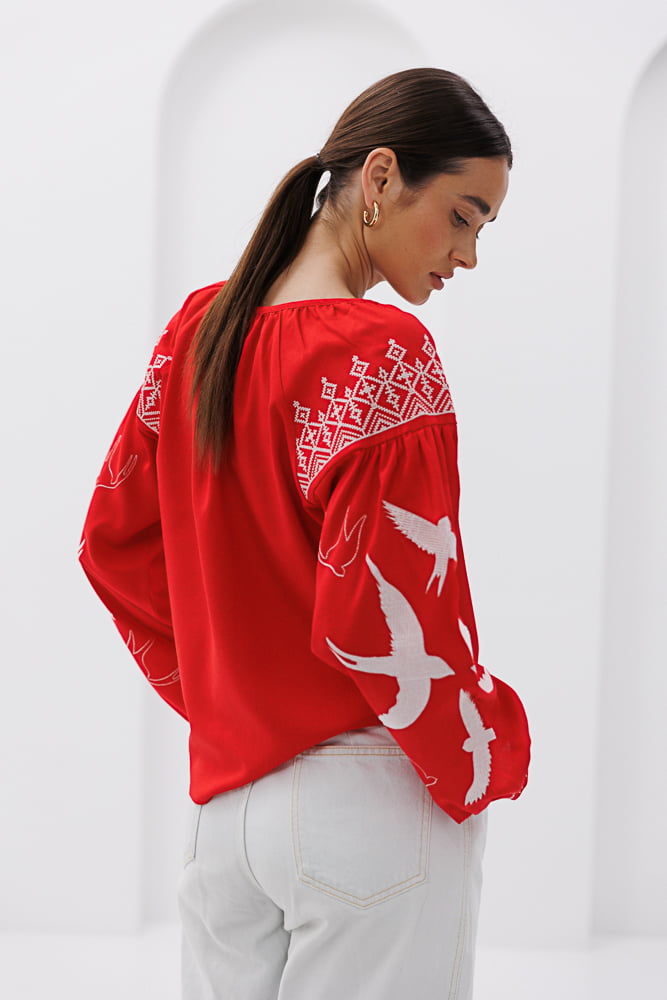 Women's red embroidered shirt with swallows in smooth embroidery.