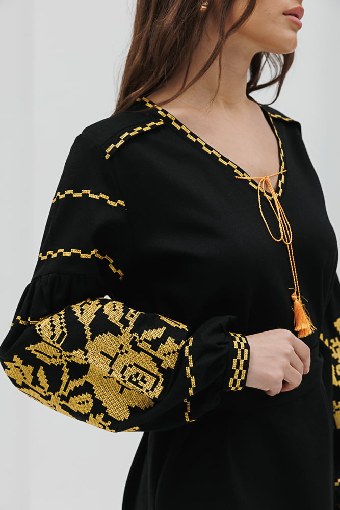 Black short embroidered dress with yellow cross-stitched roses on the sleeves.