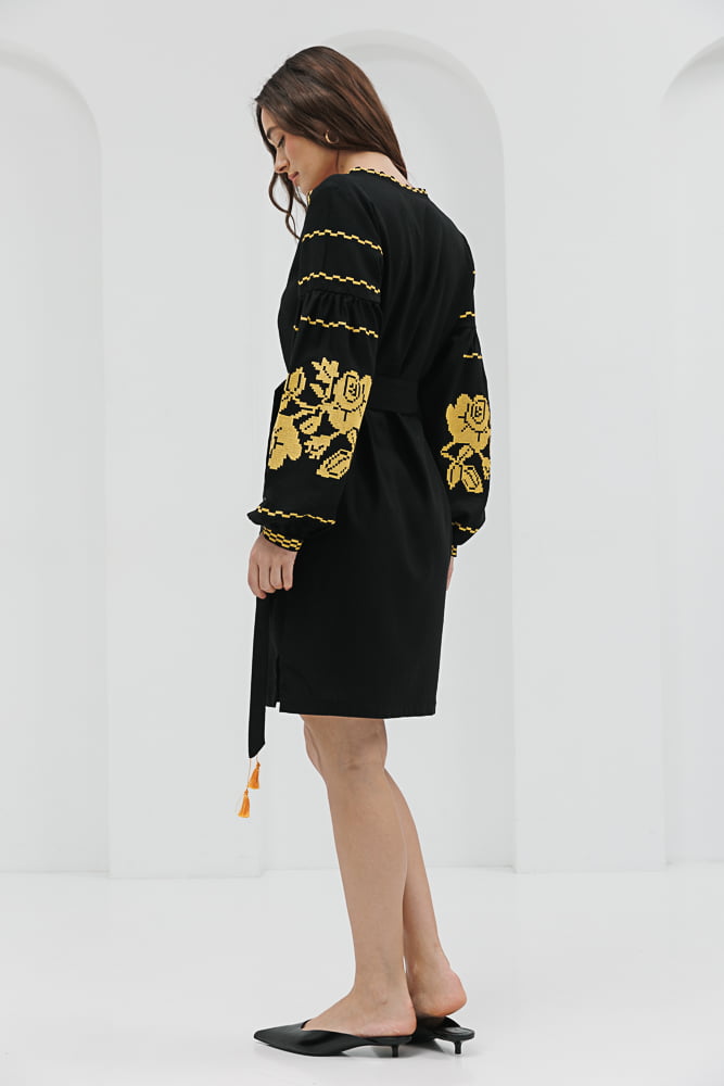 Black short embroidered dress with yellow cross-stitched roses on the sleeves.