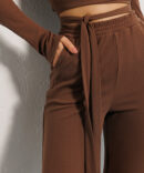 Knitted women's suit with trousers and cropped sweater brown