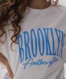 Women's oversized white T-shirt with blue Brooklyn print