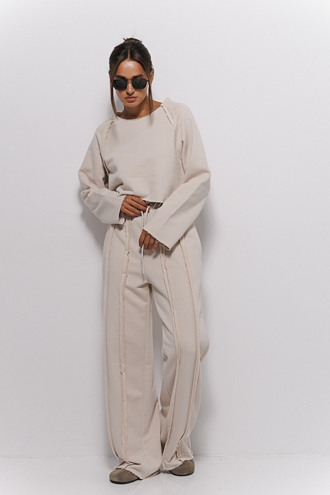 Women's light beige tracksuit with inside-out seams.