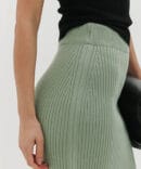 Long pistachio knit skirt with a front slit.