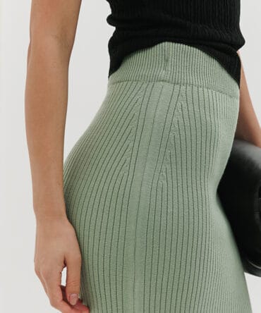 Long pistachio knit skirt with a front slit.