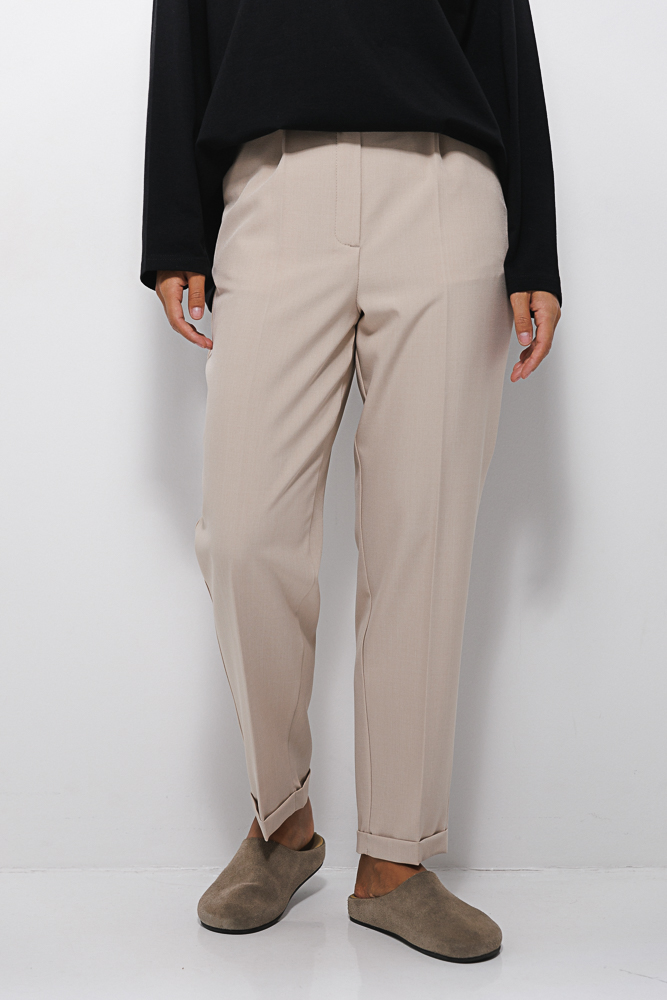 Women's beige slacks with cuffs at the bottom