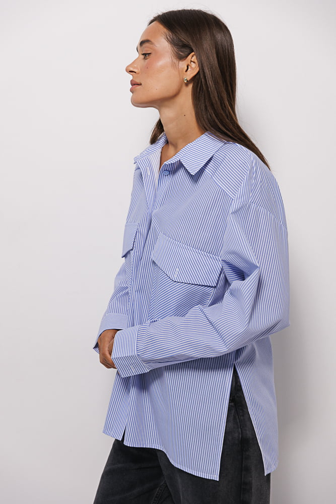 Women's shirt with chest pockets in milk color with blue stripes.