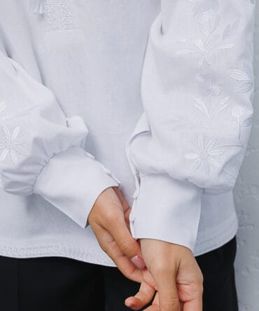 Women's white embroidered shirt with white flowers satin stitch on the sleeves