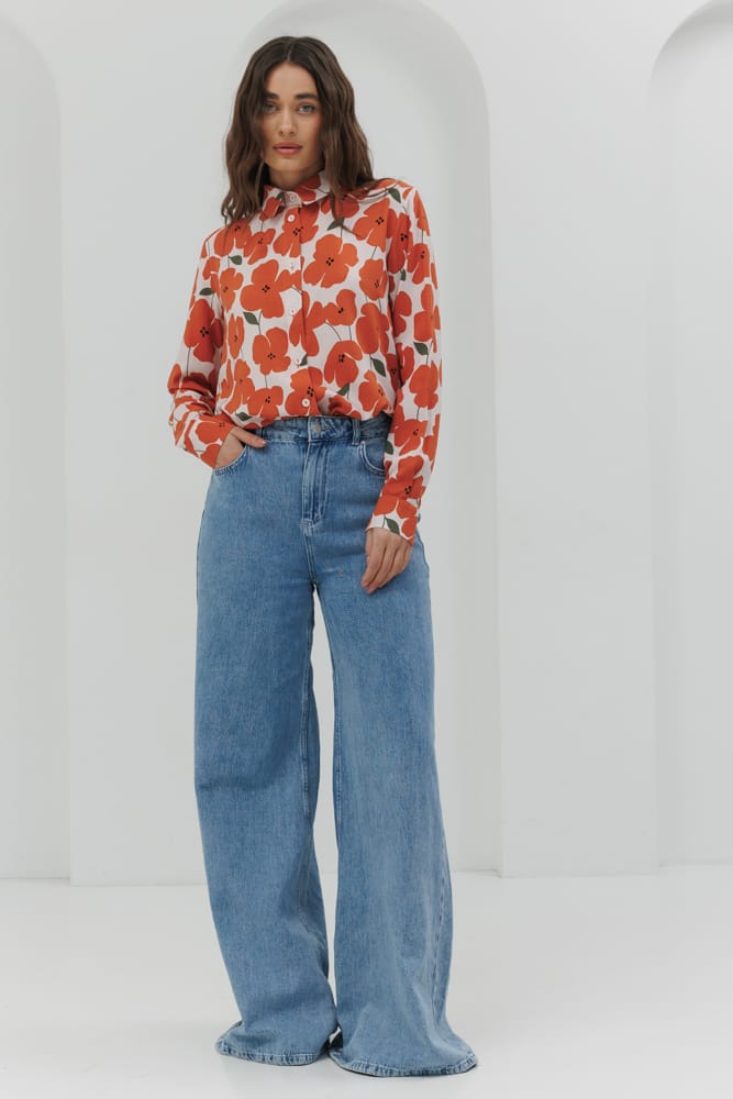 Light beige blouse with a sharp collar and orange flowers