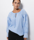 Blue women's embroidered shirt with geometry, satin stitch and ties on the cuffs