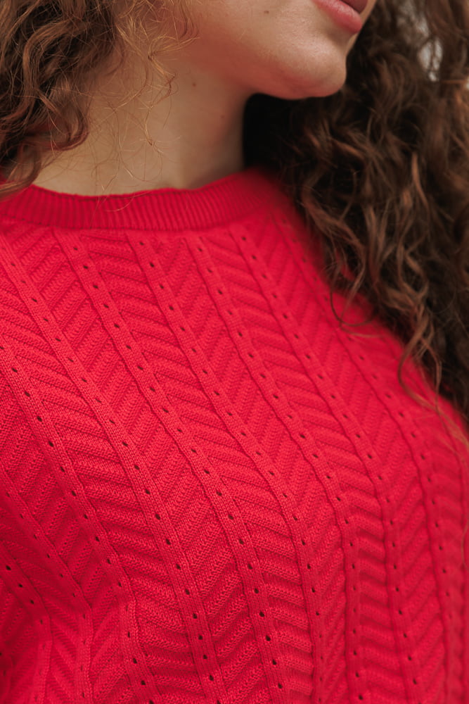 Pink-coral knitted women's t-shirt with lace patterns.