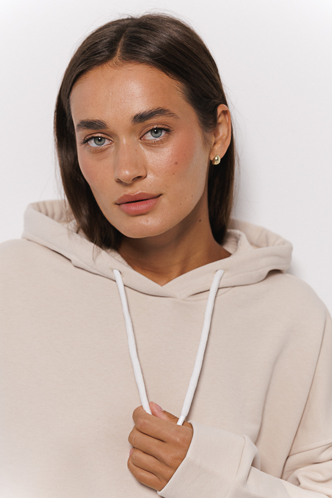 Women's oversized hoodie light beige with a drawstring in the hood