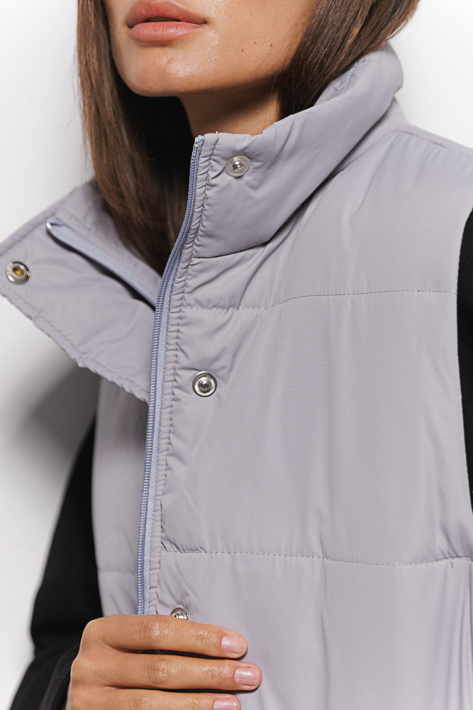 Quilted gray women's vest with waist ties.