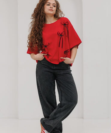 Red oversized women's t-shirt with black bows.