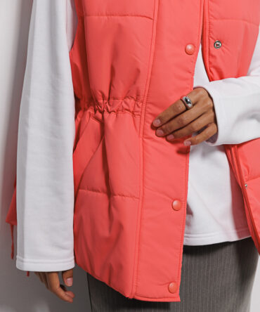 Quilted women's coral vest with waist ties.