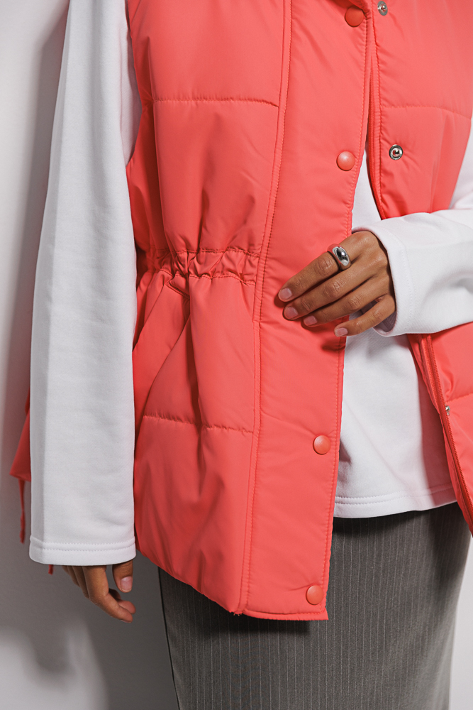 Quilted women's coral vest with waist ties.