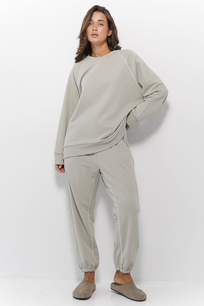 Women's sports joggers in light khaki with white piping on the front