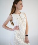 White lace dress with gold clasp on the front