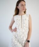 White lace dress with gold clasp on the front