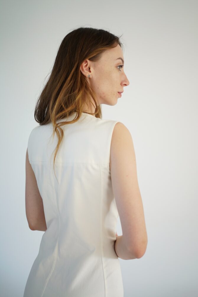 White lace dress with gold clasp on the front