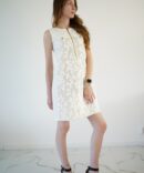 White lace dress with gold clasp on the front