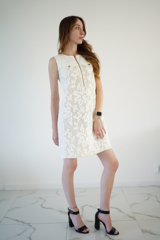 White lace dress with gold clasp on the front