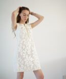 White lace dress with gold clasp on the front