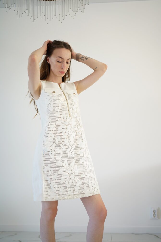 White lace dress with gold clasp on the front