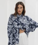 Women's dark blue blouse with pleats on the sleeves and floral print.