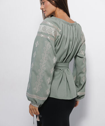 Women's olive embroidered shirt with off-shoulder design and geometric satin stitch pattern.