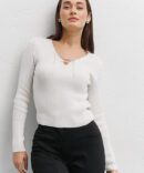 Milky knitted crop top with long sleeves and a chain at the neck