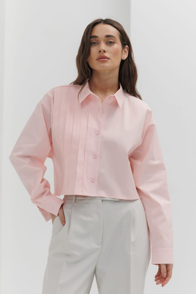 Cropped pink women's shirt with pleats on the right.