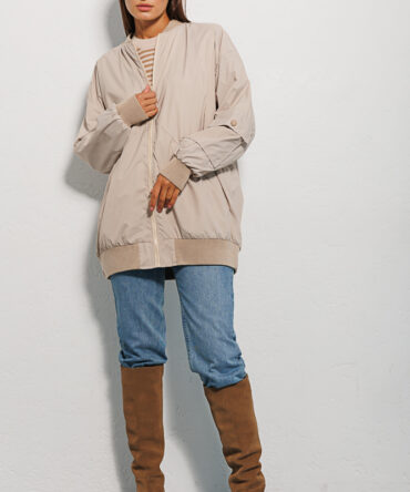 Elongated women's windbreaker light beige with a pocket on the sleeve