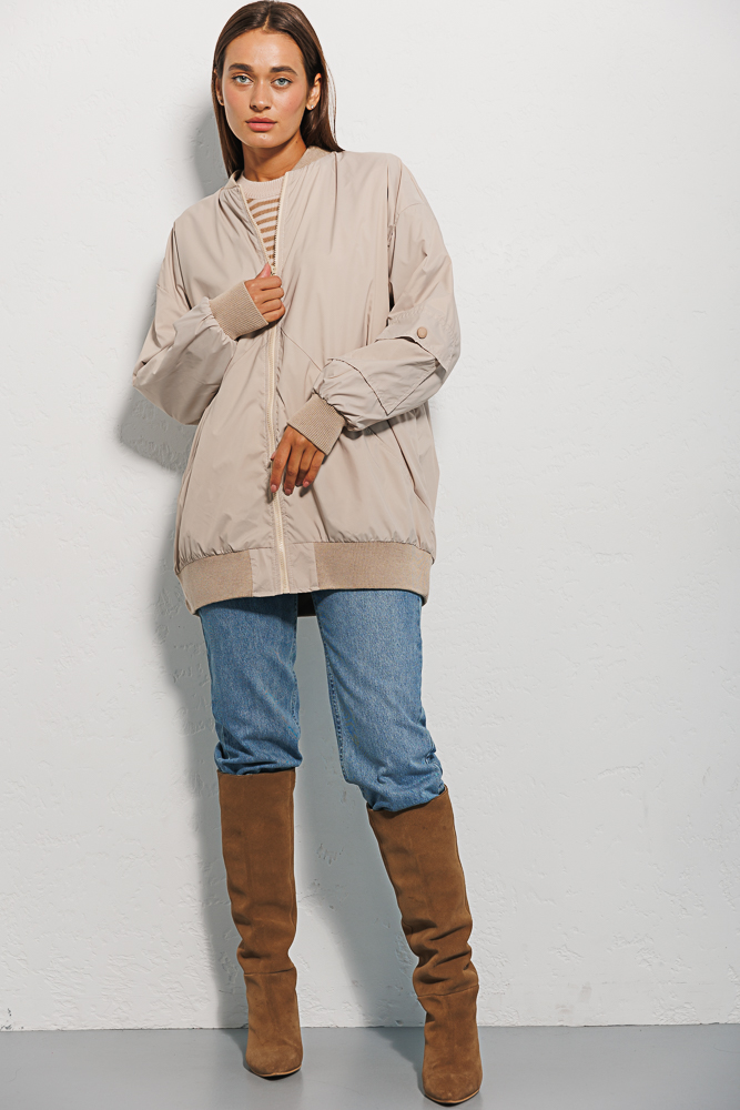 Elongated women's windbreaker light beige with a pocket on the sleeve