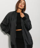 Elongated women's windbreaker black with a pocket on the sleeve