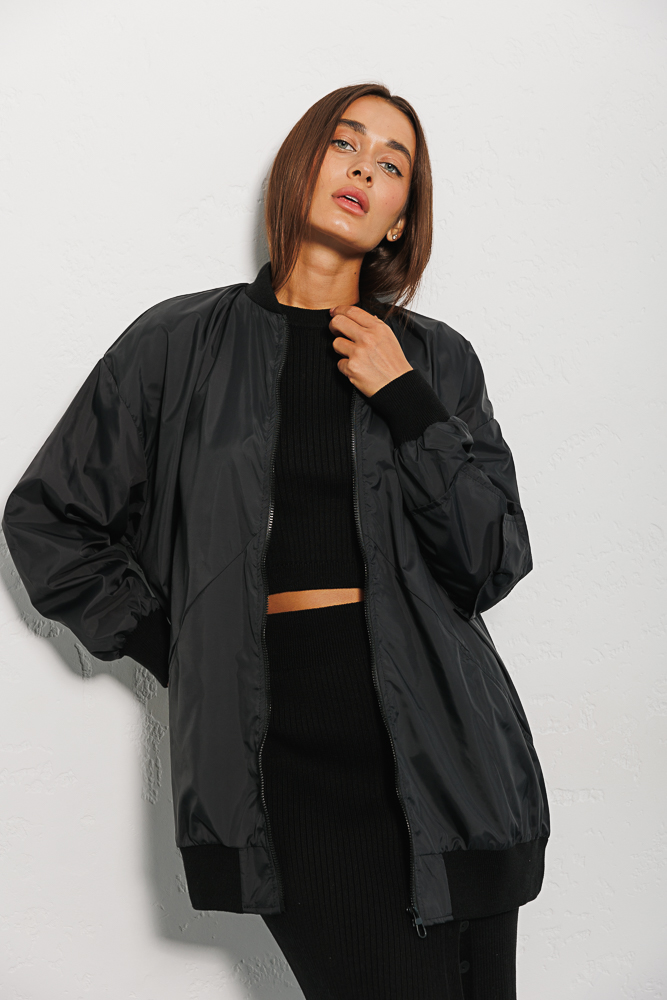 Elongated women's windbreaker black with a pocket on the sleeve