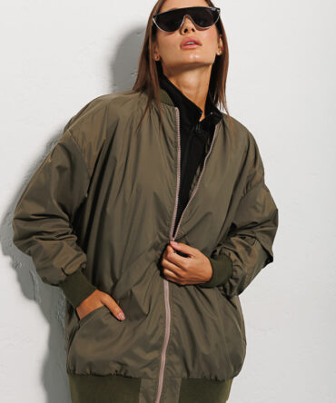 Elongated olive women's windbreaker with a pocket on the sleeve