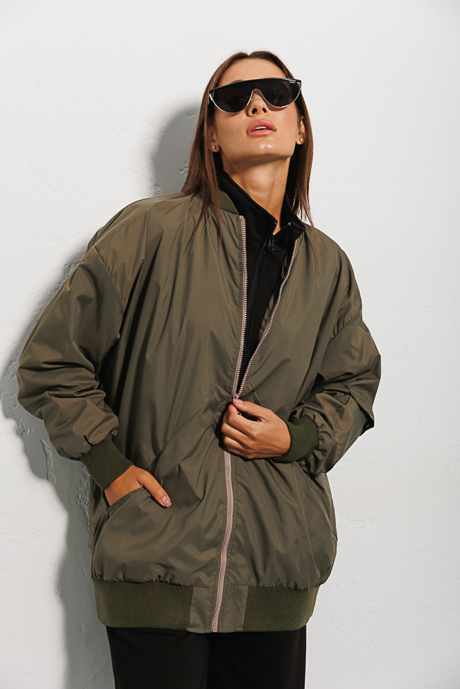 Elongated olive women's windbreaker with a pocket on the sleeve