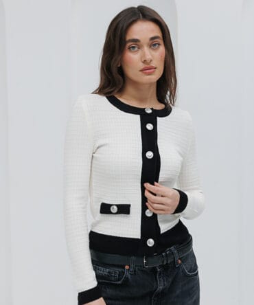 Knitted women's cardigan in a milk color with black trim