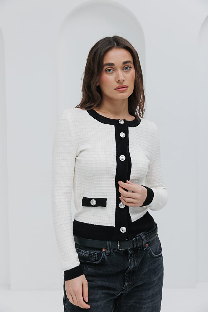 Knitted women's cardigan in a milk color with black trim