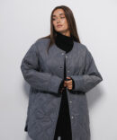 Women's elongated graphite quilted jacket with a wave pattern.