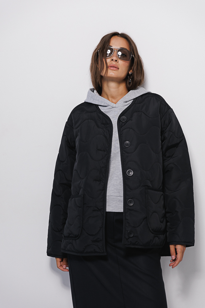 Women's black mid-season jacket, quilted in waves.