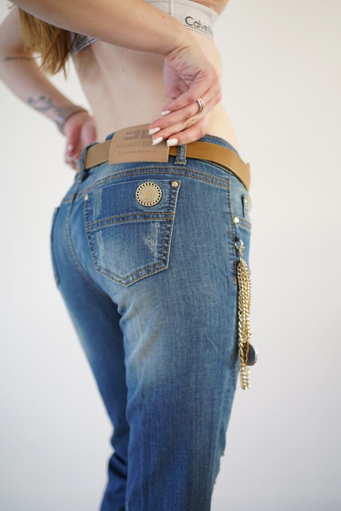 Jeans with scuffs and chains on the pockets