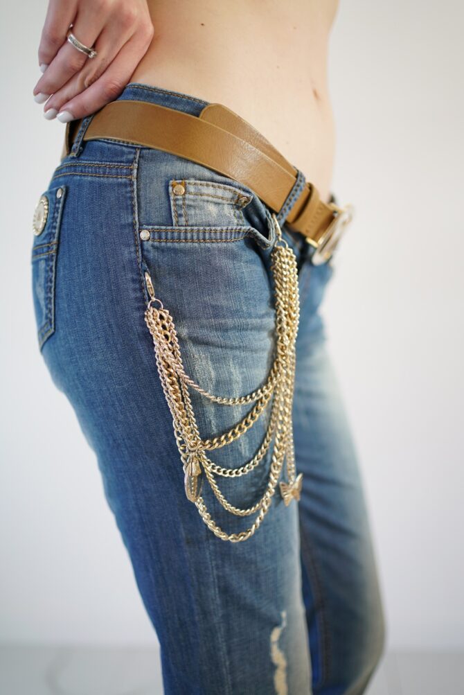 Jeans with scuffs and chains on the pockets