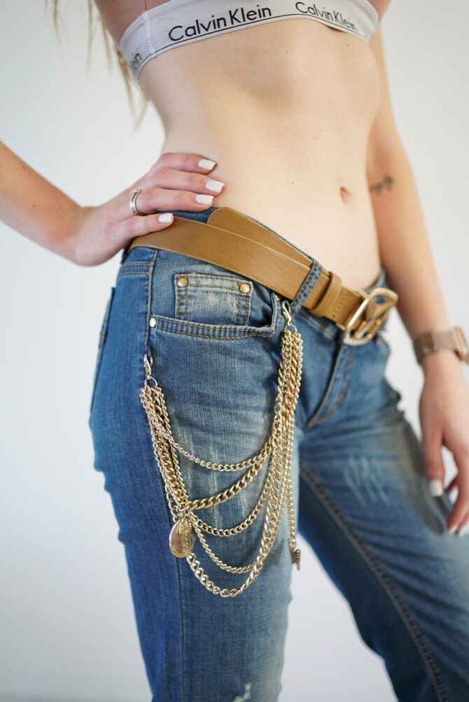 Jeans with scuffs and chains on the pockets